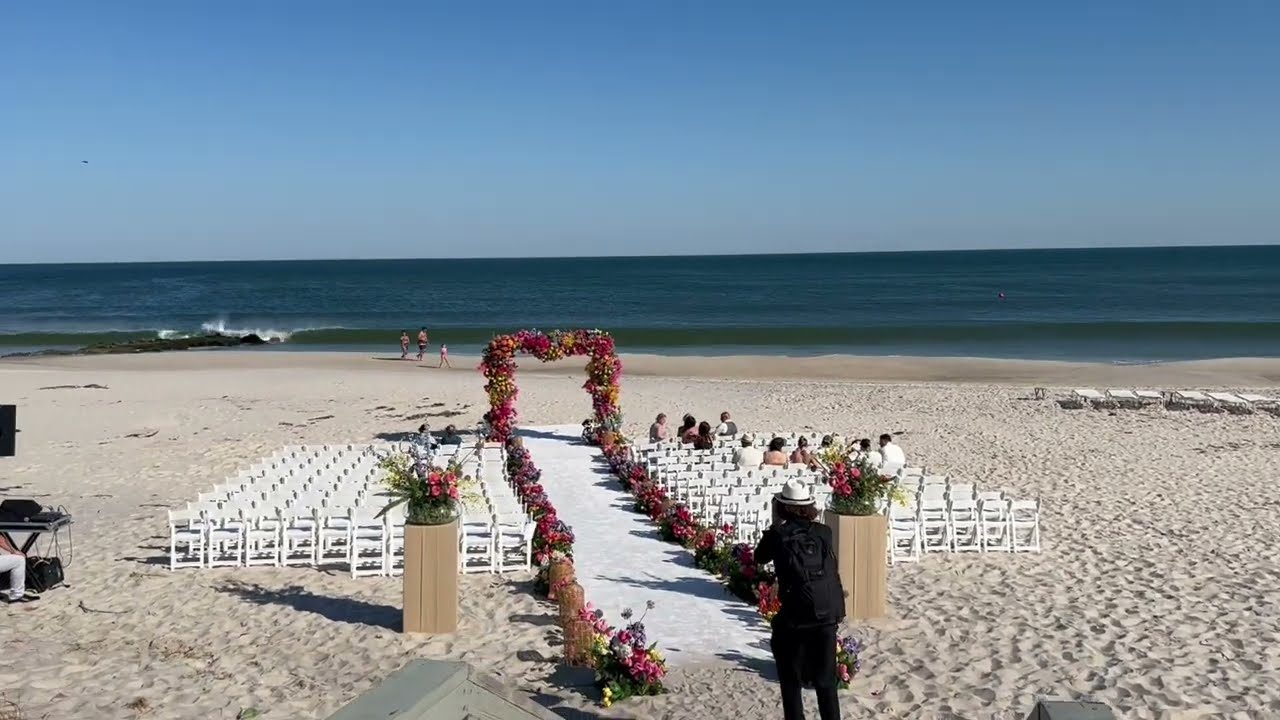 A beach ceremony setup by the water