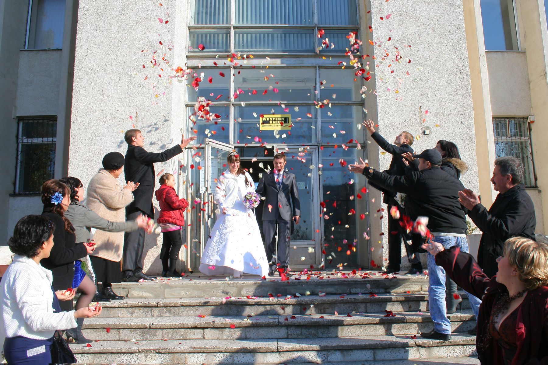 A couple laughing under falling confetti