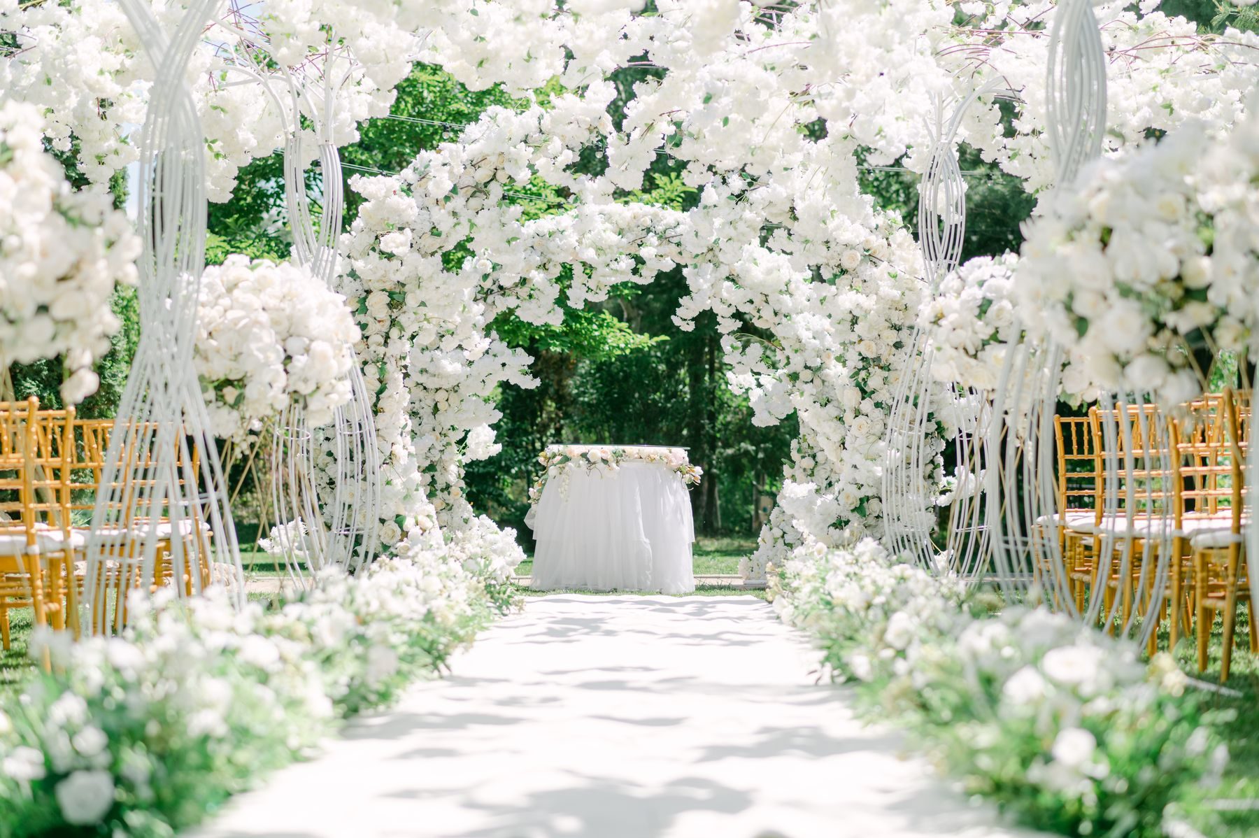 A couple under a garden flower arch