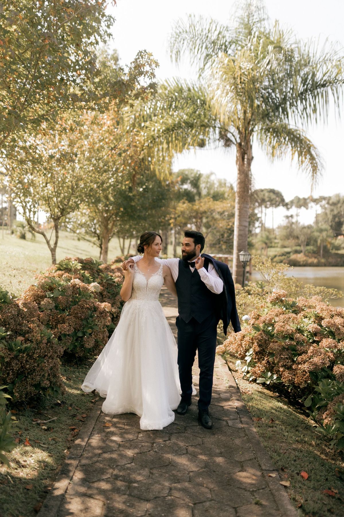 A bride and groom strolling through a garden after their ceremony