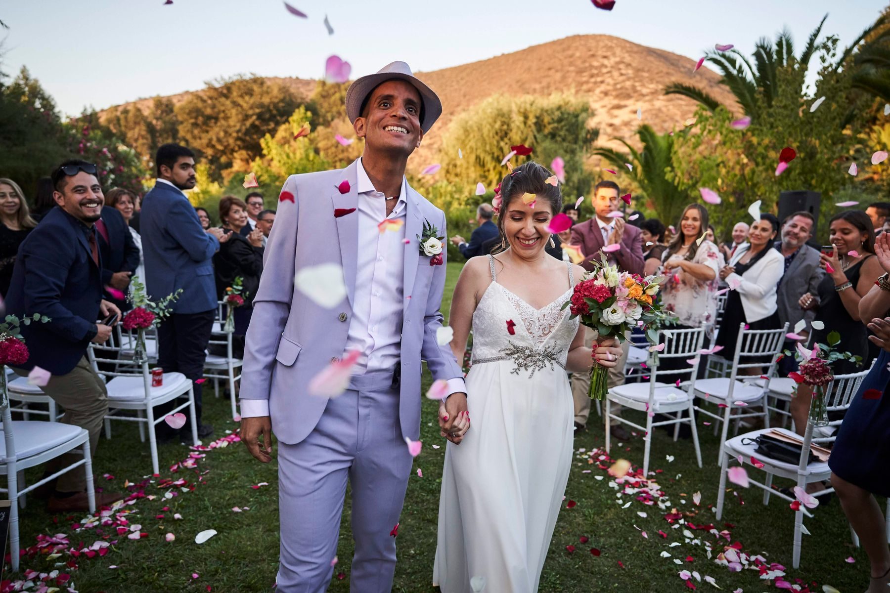 Guests showering a couple with petals